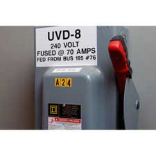 A panel with Brady black on yellow repositionable numbers and letters secured to it.