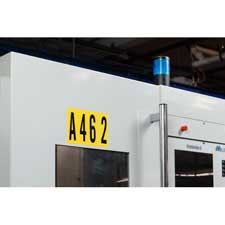 Brady black on yellow repositionable numbers and letters secured to a piece of equipment.